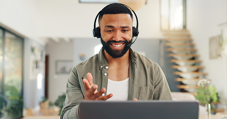 Image showing Man, headset and talking in home on video call, live streaming and presentation in online conference. Remote work, laptop or virtual assistant for contact centre or customer support at kitchen table