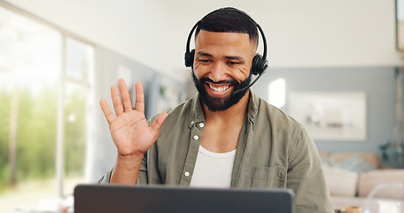 Image showing Man, wave headset and talking in home on video call, live streaming and presentation in online conference. Remote work, laptop or virtual assistant for contact centre or customer support at kitchen t