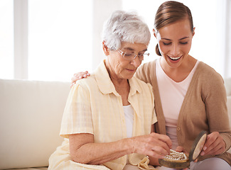 Image showing Senior woman, mother and daughter with gift for bonding, appreciation and love relaxing on sofa at home, living room and apartment. Female people, family or looking at jewelry for pearl heirloom