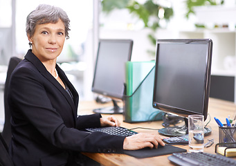 Image showing Business woman, portrait and senior professional office manager at a computer with a smile for digital work. Tech, desk and happy executive with online job and confidence from company admin career