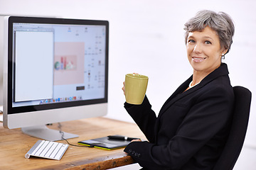 Image showing Business woman, portrait and senior professional in office at computer with coffee and email. Tech, desk and happy executive with online job and confidence from startup career with operations manager