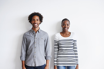 Image showing Couple, smile and portrait by white wall in fashion with confidence, casual style and model aesthetic. Black woman, and face of man with trendy apparel, edgy clothes and pride with happiness or relax