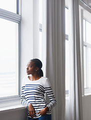 Image showing Woman, relax and thinking by window in new house with confidence for real estate investment and mortgage. African homeowner, person and thoughtful with future home ideas and relocation in living room