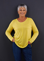 Image showing Smile, fashion and portrait of woman in studio with casual, trendy and bright tshirt for outfit. Confident, happy and senior female person from Mexico with cool style isolated by black background.