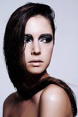 Image showing Woman, smokey and eyes with makeup in studio for art and beauty, thinking and wondering with thoughts for cosmetics. Female person, isolated and white background with eyeshadow or cosmetology.