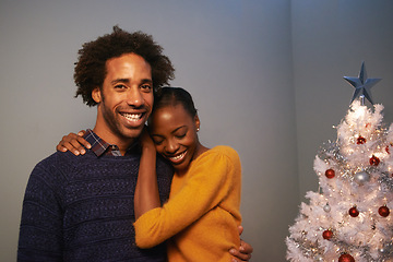 Image showing Couple, Christmas tree and holiday celebration in home for happiness vacation or love, giving or bonding. Man, woman and smile with lighting decoration for winter season event, together or lounge