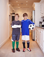 Image showing Children, friends and portrait with soccer ball at house or training game in kit or competition, cardio or apartment. Male people, face and football in kitchen or player practice, exercise or workout