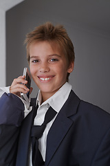 Image showing Portrait, child and pretend suit on boy, smartphone or business call for dream job or dress up on kid. Smile, happy in clothes on career day for school, talk on communication technology with costume