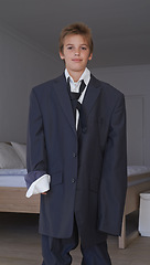 Image showing Portrait, boy and pretend suit on male person, oversized business clothes for dream job on child. Dress up, kid and happy smile on career day for school, costume and standing in home bedroom