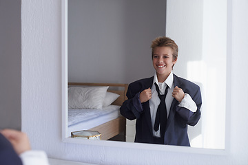 Image showing Happy, boy and pretend suit on male person, business wear for dream job or dress up on kid. Smile, clothes for career aspirations day in school, costume and standing in bedroom mirror in home