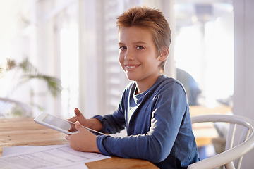 Image showing Child, homework and tablet on table in portrait, school work for learning and educational development on technology. Digital search, internet and online help in home, happy and smile on studying kid