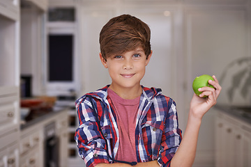 Image showing Boy, smile and portrait in kitchen with apple for nutrition, breakfast and health in house for snack. Child or kid in home with fruit for vitamin, nutrient and fibre for meal, delicious and raw