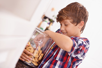 Image showing Cookie, jar and child in home eating from glass, container or happy with sweets in kitchen. House, snack and kid craving a taste of sugar and excited for biscuit and unhealthy food with energy