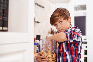 Image showing Eating, cookies and portrait of child in home with glass, container or sneaking with a jar of sweets. House, kitchen and kid craving a taste of sugar with biscuit addiction or snack on unhealthy food