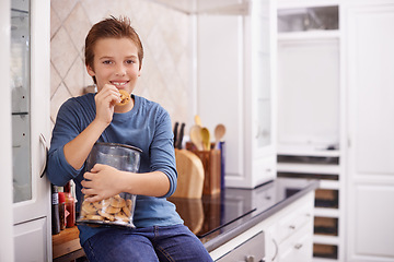 Image showing Eating, cookies and portrait of child in home with glass, container or happy with jar of sweets on kitchen counter. House, snack and craving taste of sugar from addiction to unhealthy food or biscuit