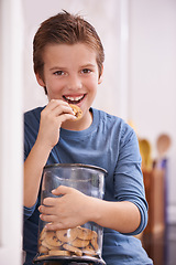 Image showing Eating, cookies and portrait of child in home with glass, container or happy with jar of sweets in kitchen. House, snack and craving taste of sugar from addiction to unhealthy food or biscuit