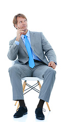 Image showing Think, chair and businessman in studio thoughtful for mission or decision, vision and planning for corporate career. Person, white background and ideas for project development, pensive and insight.