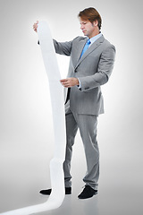 Image showing Businessman, documents and receipt with finance for bills, expenses or list on a gray studio background. Man or employee checking financial paperwork or report for audit or budget planning on mockup