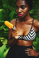 Image showing Black woman, fashion and style with popsicle in garden with confidence for glamour, bra and summer outfit. Female person, clothes and trendy look in outdoor on hot weather for edgy and modern.