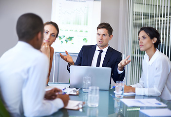 Image showing Coworker, office and argue in meeting with laptop for contract, paperwork and discussion for update. Business people, boardroom and client in table with strategy, feedback and company growth.