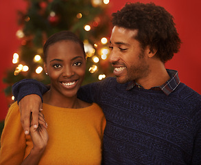 Image showing Christmas, tree and portrait of black couple with love in home on holiday or hug on vacation with happiness. Festive, event and people embrace with care and support or excited to celebrate together