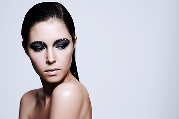 Image showing Woman, smokey and eyeshadow with makeup in studio for art and beauty, thinking and wondering with thoughts for cosmetics. Female person, isolated and white background, mockup space and glamour