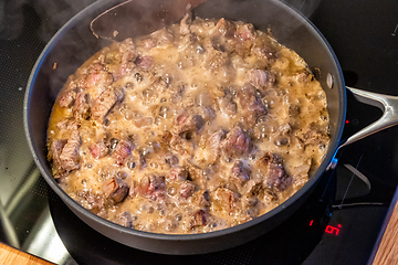 Image showing the meat is stewed in a pan