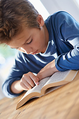 Image showing Home, boy and kid with reading textbook for homework with learning for child development, education and growth. Homeschool, notes and study with revision for exams or test and school project