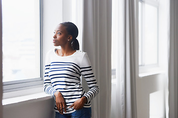 Image showing Woman, serious and thinking by window in new home with confidence for real estate investment and mortgage. African homeowner, thoughtful and relax with future house ideas or relocation in living room