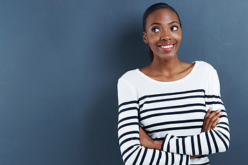 Image showing Black woman, happy and thinking in studio of fashion, inspiration and trendy by blue background. African designer, idea and arms crossed for creativity and planning a small business for funky clothes