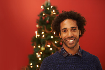 Image showing Man, portrait and smile at Christmas holiday for relax weekend for festive season, red background or mockup space. Male person, face and happy or ornament decoration or present, giving or celebration