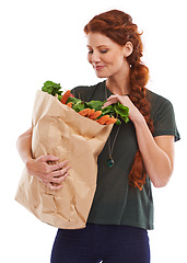 Image showing Woman, grocery bag and vegetables nutrition in studio or healthy eating or food vitamins, fiber or white background. Female person carrots and wellness snack or lose weight diet, mockup space or meal