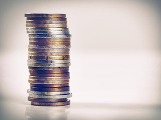 Image showing Closeup, studio and stack of coins for saving, budgeting and counting money in recession or retrenchment. Bronze, silver and change to bank for small investment and illustration of value of money