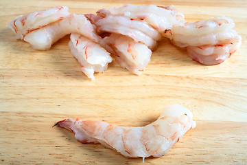 Image showing Raw prawns on chopping board