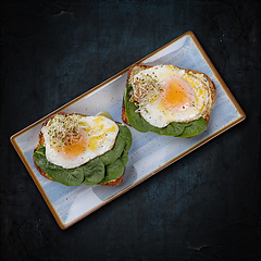 Image showing Avocado toast topped with fried eggs