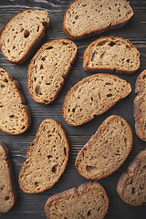 Image showing Artisan sliced bread on wooden surface