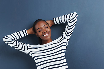 Image showing Black woman, happy and eyes closed in studio to relax, peace and fashion top by blue background. African student, break and rest on hands for education, wellness and positive gen z with funky clothes