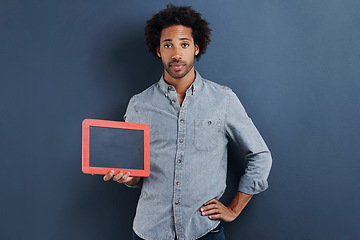 Image showing Blackboard, portrait or man with mockup in studio for news, announcement or offer on blue background. Frame, presentation or face of guy model show space for promotion, info or sign up, guide or deal