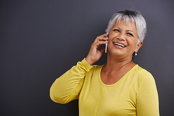 Image showing Smile, phone call and senior woman in studio for communication, good news or gossip. Contact, mockup and elderly female person on mobile conversation with cellphone for talking by black background.