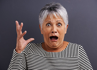 Image showing Shock, portrait and senior woman in studio with fear, scared and terror facial expression. Surprise, crazy and elderly female person with terrified or horror face isolated by black background.