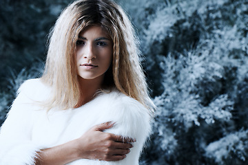 Image showing Woman, winter and fashion portrait by tree, attitude and pride for fur coat or warm clothes. Female person, serious face and confident in fluffy jacket or nature, forest and trendy or outdoor outfit