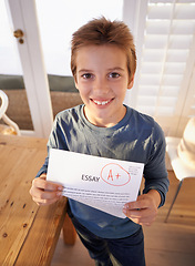 Image showing Child, portrait and paper exam for school learning or student essay in home or scholarship, goals or academic. Male person, face and document pride for education mark or study, results or success