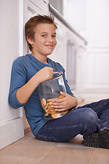 Image showing Eating, cookies and portrait of child in home with glass, container or happy with jar of sweets on floor. House, kitchen and kid craving a taste of sugar with biscuit as snack and unhealthy food