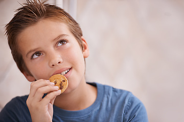 Image showing Face, thinking any boy eating cookie in home for hunger, snack or treats inspiration. Future, planning or vision with happy young teen kid biting food, biscuit or baked goods in apartment closeup