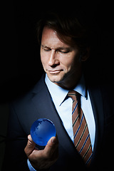 Image showing Man, suit and orb in studio for globe or earth for communication and connectivity in business. Leader or ceo with sphere, crystal or circle in hand for economy, world or future for corporate