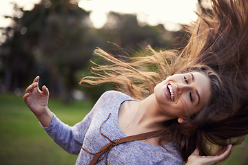 Image showing Woman, happy and dancing with hair in wind, female person in nature with carefree creative and moving motion. Summer, enjoy or student on holiday with excited, head and smile for vacation freedom
