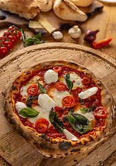 Image showing Pizza topped with fresh tomatoes and mozzarella