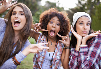 Image showing Funny face, portrait and friends in a park with silly, fun or bonding on vacation, weekend or reunion in nature. Crazy, expression and gen z women in a forest with goofy, comic or joke and gesture