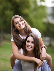 Image showing Girl friends, smile and portrait with piggyback in park with bonding and fun on campus outdoor. Students, grass and happy together in a university garden on a break for summer holiday in nature