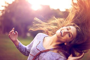 Image showing Smile, dance and hair in nature for happy woman person, freedom and excited in park. Confidence, dancer and summer sunshine or sunset with lens flare, joy and fun from good news or achievement